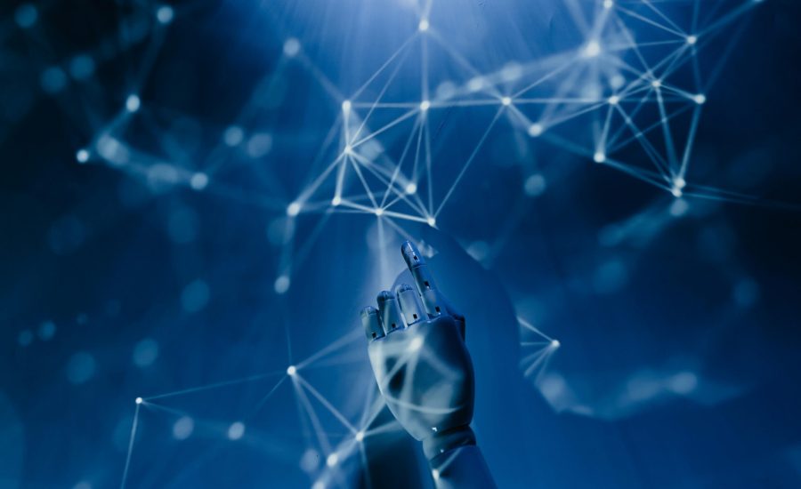 Free A robotic hand reaching into a digital network on a blue background, symbolizing AI technology. Stock Photo